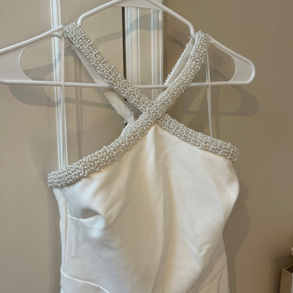 Likely white beaded jumpsuit